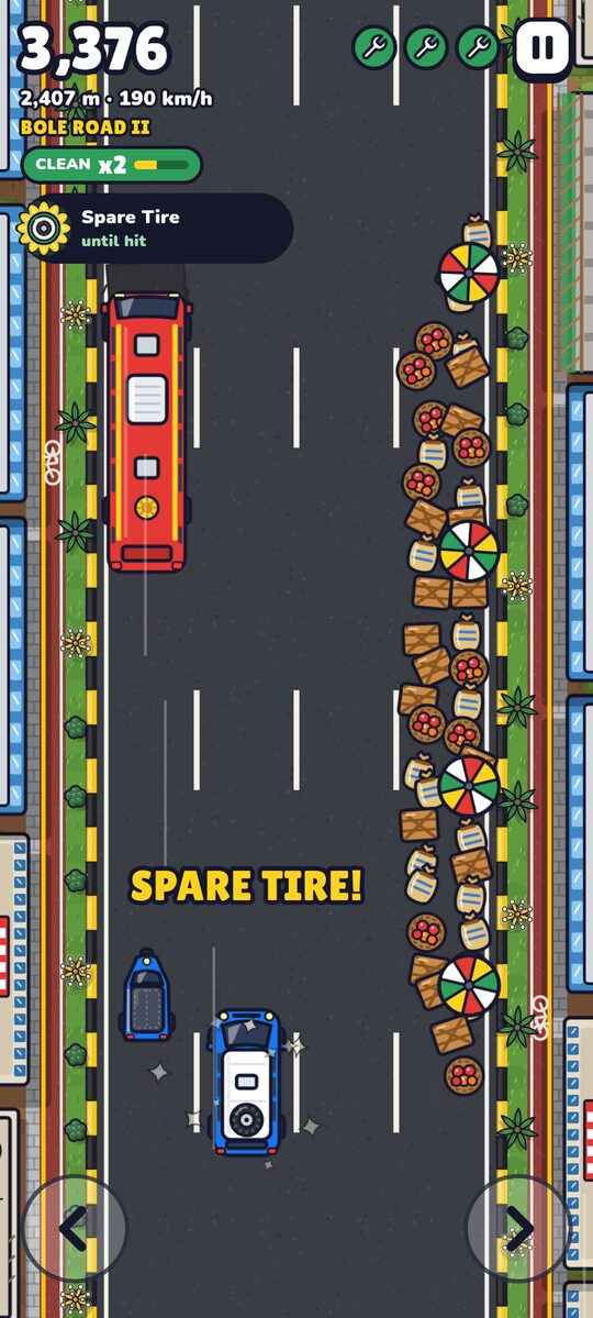 A market spill blocking a lane, with sacks, crates and umbrellas